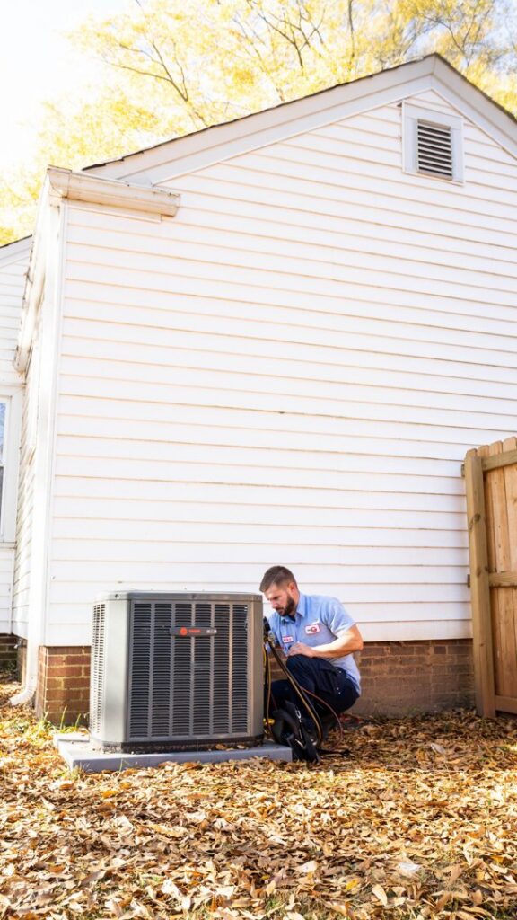 An HVAC technician performing service on an outdoor air conditioning unit for General Air Conditioning Service Corp in Greenville, SC.