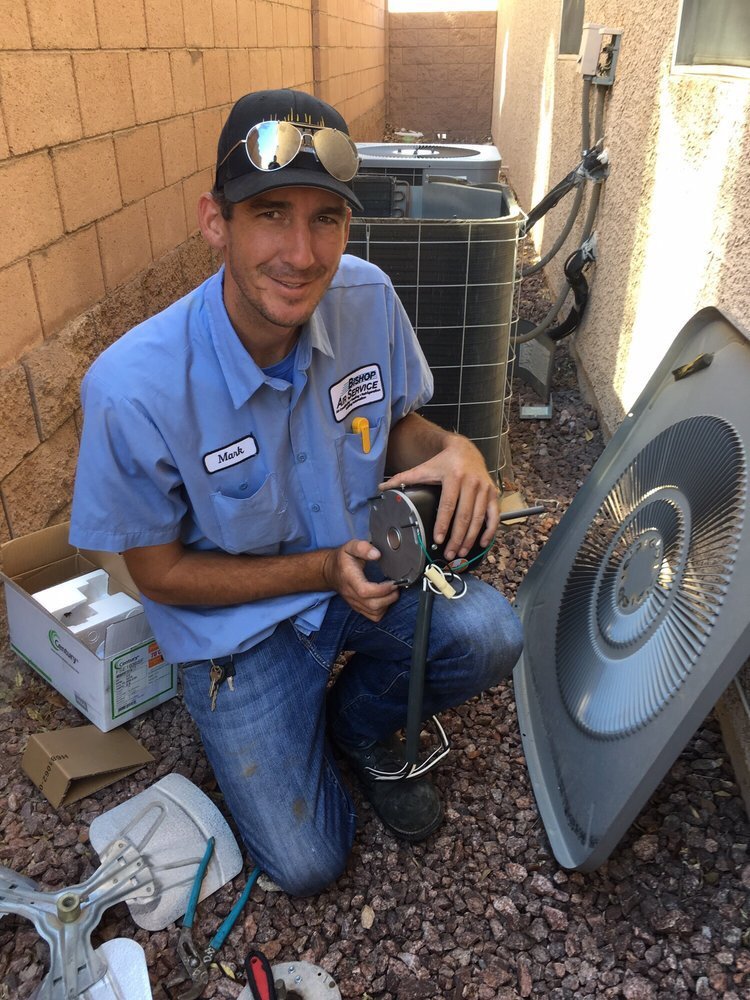 An HVAC technician repairing an AC unit motor for Bishop Air Service in Henderson, NV.