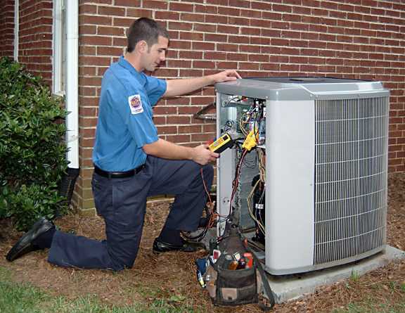An HVAC technician repairing an outdoor AC unit at a residential property for AC Repair DC in Washington, DC