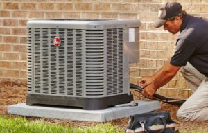 An HVAC technician repairing an outdoor air conditioning unit for Mike Watson Heating and Cooling in Wichita, KS.