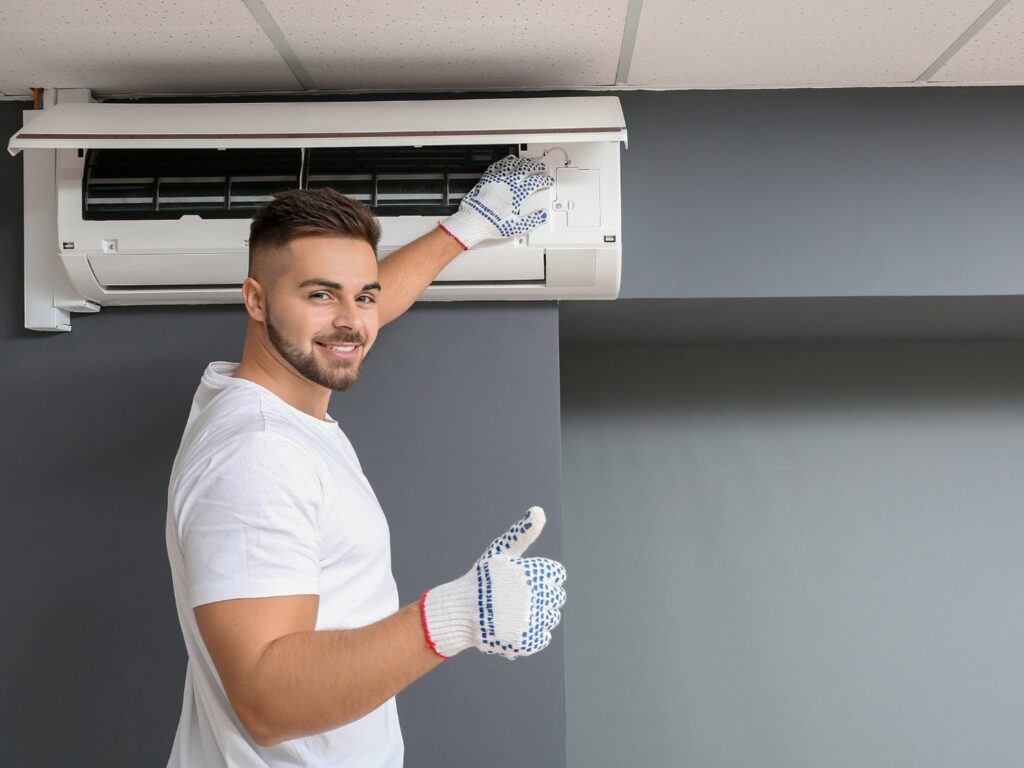 An HVAC technician repairing a ceiling-mounted AC unit for ChillTek AC Repair Glendale in Glendale, AZ.