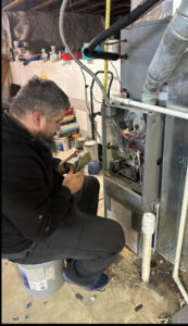 An HVAC technician repairing a furnace during a service appointment for Airtechservicesohio.com in Columbus, OH