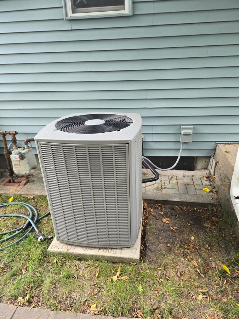 An HVAC technician repairing an open furnace unit in a basement, performing heating services for 24/7 Heating & Air, LLC in Grand Island, NE.