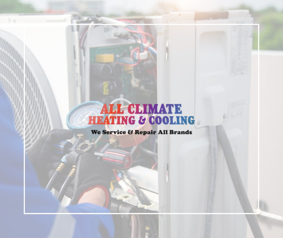 An HVAC technician repairing an indoor heating and cooling unit at All Climate Heating & Cooling in Redmond, WA