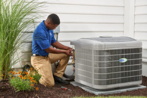 An HVAC technician repairing an outdoor air conditioning unit for Larry's Heating and Cooling, Inc. in Yankton, SD.