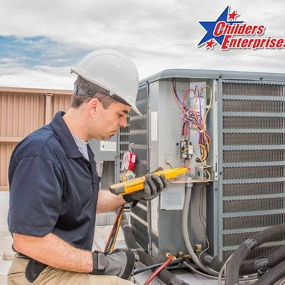 An HVAC technician repairing an outdoor air conditioning unit for Childers Air Plumbing & Electric in Beckley, WV.