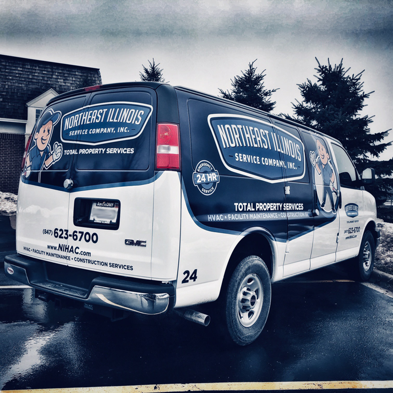 An HVAC technician repairing an outdoor air conditioning unit for Northeast Illinois Service Company, Inc. in Waukegan, IL