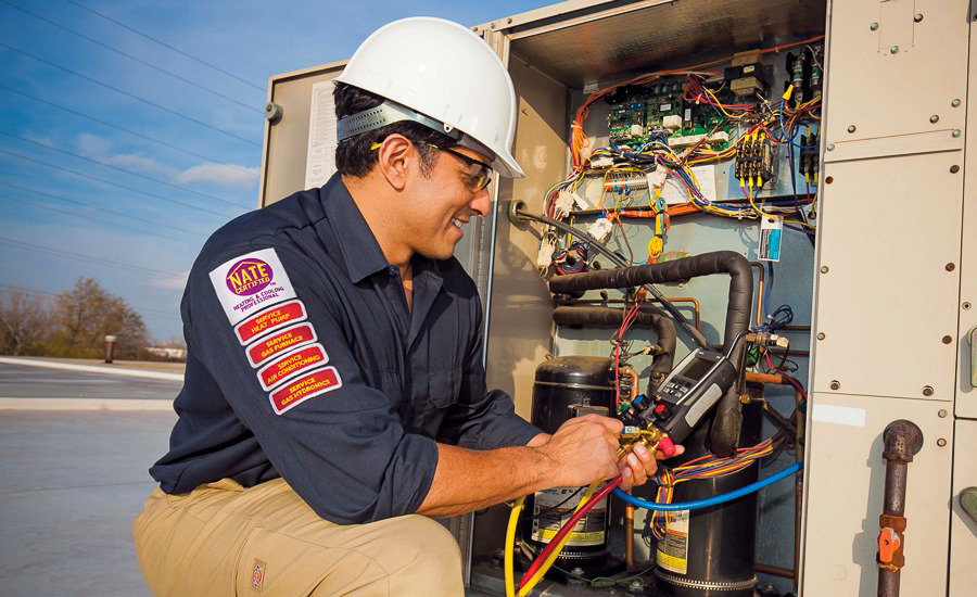 An HVAC technician repairing a commercial rooftop unit for AirTemp Heating & Cooling in Nashville, TN.