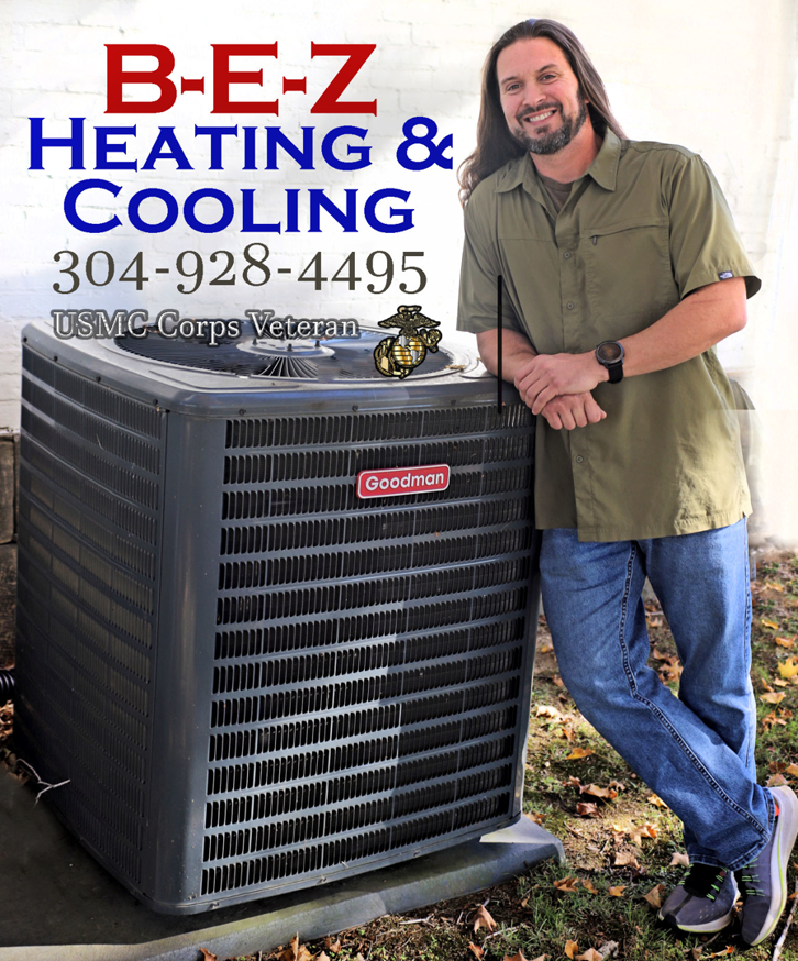 An HVAC technician from BEZ Heating and Cooling, LLC John Creamer, standing next to a residential AC unit in Huntington, WV.