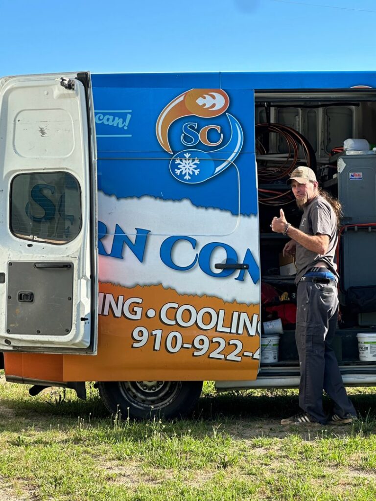 An HVAC technician giving a thumbs-up next to a Southern Comfort Heating/Cooling/Gas service van in Fayetteville, NC.