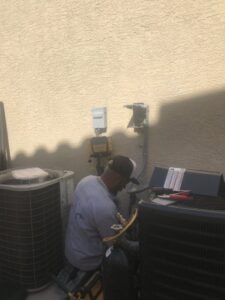 An HVAC technician from Allstar Heating & Cooling servicing an outdoor AC unit in Port Richey, FL