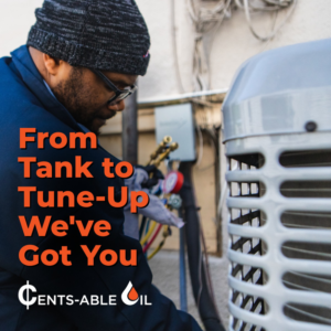 An HVAC technician from Cents-Able Oil servicing an outdoor air conditioning unit in New Haven, CT.