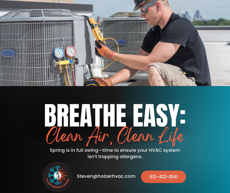 An HVAC technician servicing an outdoor air conditioning unit for Holzer Heating And Cooling in Savage, MN
