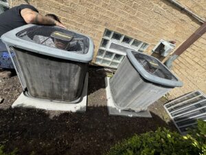 An HVAC technician servicing an outdoor AC condenser unit for HVAC Royal Service Inc in Chicago, IL.
