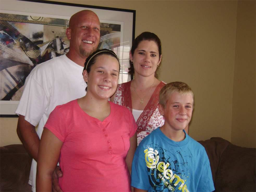 An HVAC technician servicing an outdoor air conditioning unit with tools and gauges for J AND J HVAC L.L.C in Mesa, AZ