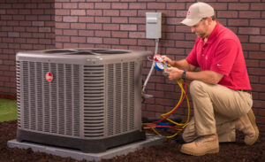 An HVAC technician servicing an outdoor air conditioning unit with gauges for Mike Watson Heating and Cooling in Wichita, KS.