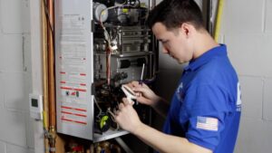 An HVAC technician from BC Express Inc Heating & Air Conditioning servicing an indoor boiler in Toms River, NJ.