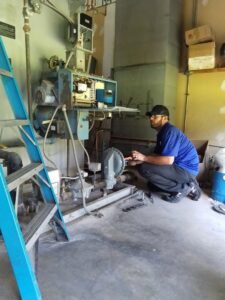 A CM3, Inc. HVAC technician servicing a commercial boiler or furnace unit in Wichita, KS.