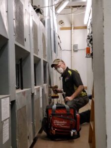 An HVAC technician servicing commercial heating and cooling units for Larry's Heating and Cooling, Inc. in Yankton, SD.
