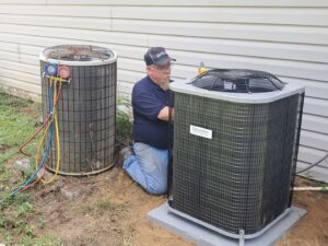 An HVAC technician servicing an outdoor condenser unit for Sterling Service of Florida Inc in Tallahassee, FL.