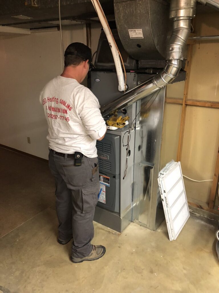 An HVAC technician servicing a residential furnace for 5280 Cooling Heating & Refrigeration in Lakewood, CO