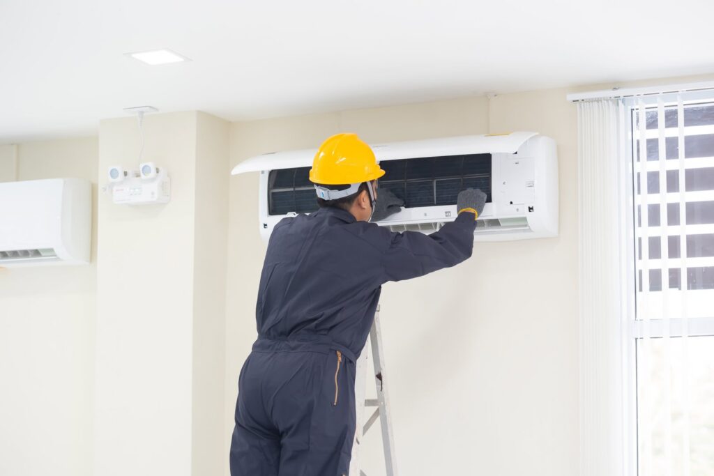 An HVAC technician servicing an indoor mini-split air conditioning unit for 5 Star Charleston Heating and Air in Charleston, SC.