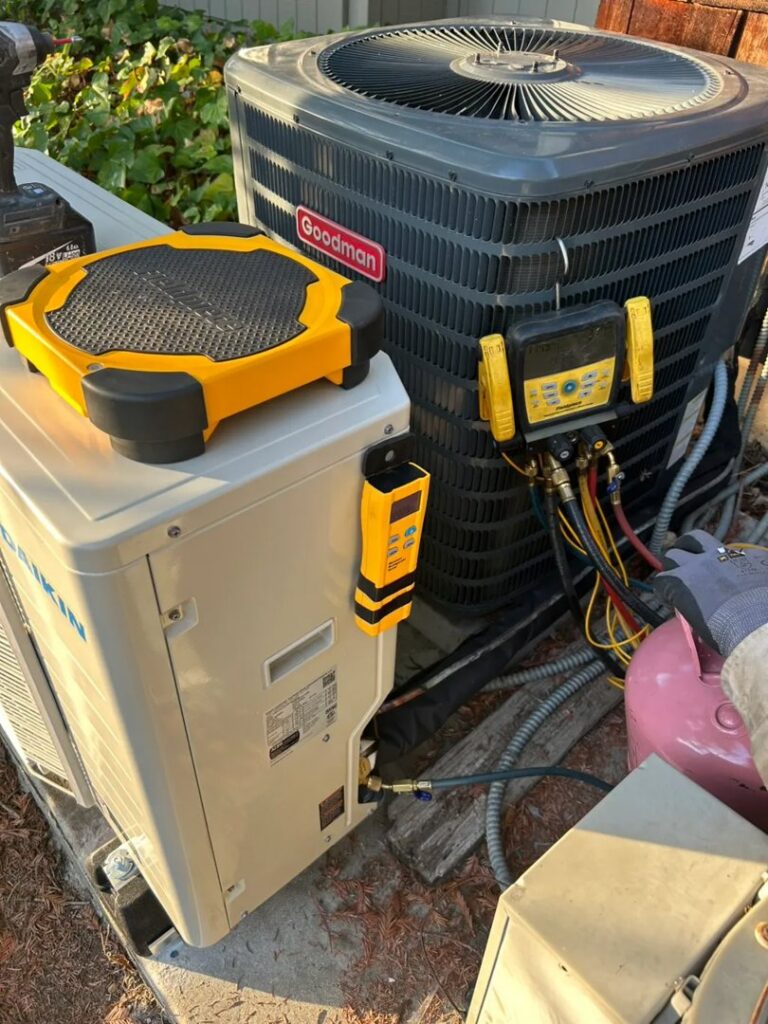 An HVAC technician from Fuse HVAC & Appliance Repair Boston servicing multiple outdoor units in West Roxbury, MA.