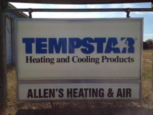 An HVAC technician servicing an outdoor air conditioning unit for Allen's Heating & Air Conditioning in Charlestown, IN.