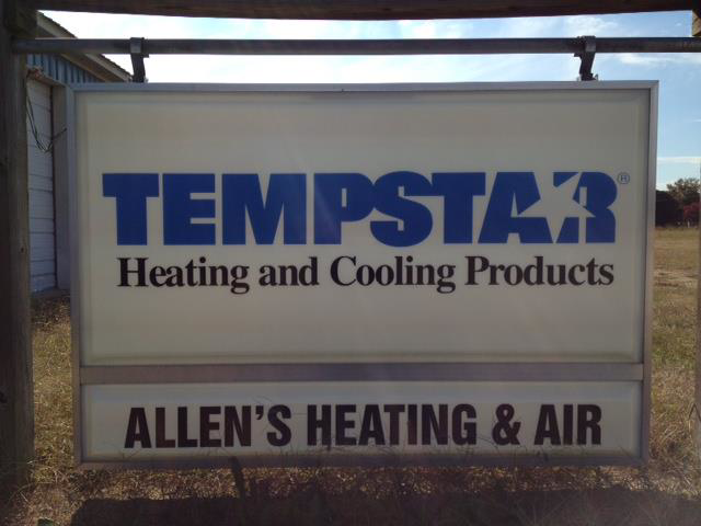 An HVAC technician servicing an outdoor air conditioning unit for Allen's Heating & Air Conditioning in Charlestown, IN.