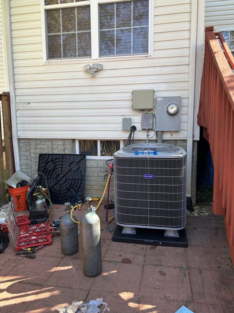 An HVAC technician servicing an outdoor AC unit with gauges and tools at Residential Express Heating & Air in Sterling, VA.