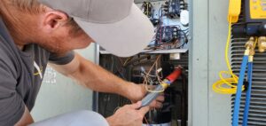 An HVAC technician from Arrow Pro Services servicing an outdoor air conditioning unit in Gilbert, AZ
