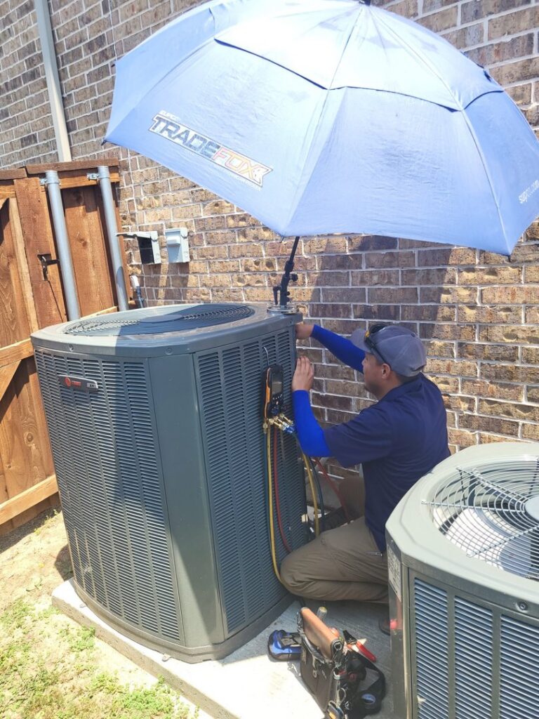 An HVAC technician servicing an outdoor air conditioning unit with diagnostic tools for Modern Air Services in Fort Worth, TX.
