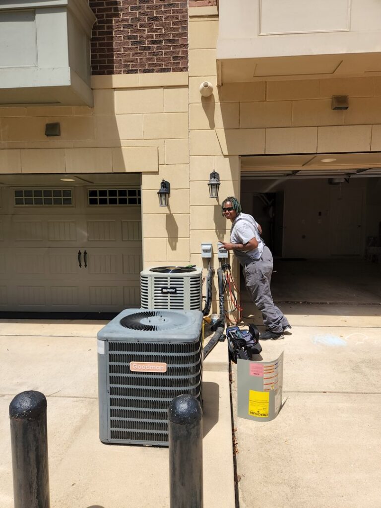 An HVAC technician servicing outdoor condenser units for ECA DuctWorks in Reston, VA