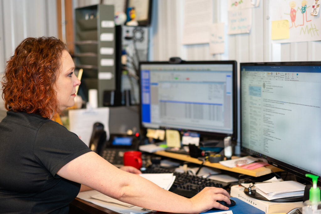 An HVAC technician from Beman's Sales & Service servicing a refrigeration unit in Hastings, NE.