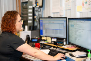 An HVAC technician from Beman's Sales & Service servicing a refrigeration unit in Hastings, NE.