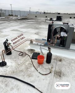 An Empire Tech, Inc. technician servicing a rooftop HVAC refrigeration unit in Schaumburg, IL.
