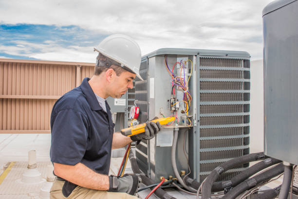 An HVAC technician servicing a commercial rooftop unit for AirTemp Heating & Cooling in Nashville, TN.