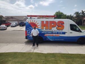 An HVAC technician standing by a branded service van for HPS Plumbing Services Bakersfield, CA.