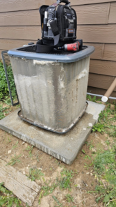 HVAC tools on top of an outdoor AC unit with dirty coils, ready for service by Erik's Quality HVAC LLC in Greeley, CO.