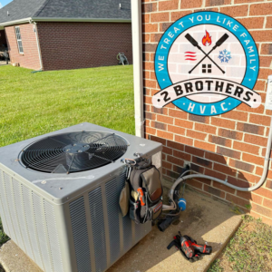 HVAC technician's tools next to an outdoor AC unit, ready for service by 2 Brothers HVAC in Seguin, TX