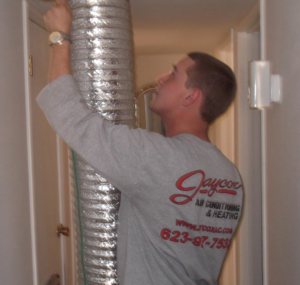 An HVAC technician from Jaycox Air Conditioning working on an air duct system in Surprise, AZ