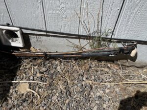 An HVAC technician performing maintenance on an outdoor condenser unit for Desert Air, LLC in Sun Valley, NV.