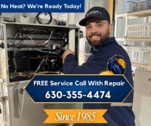 An HVAC technician from A All Temp Inc. Heating & Cooling working on a furnace in Naperville, IL.