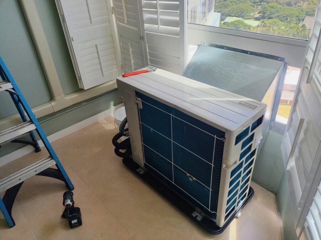 An HVAC technician performing service on an indoor mini-split unit, demonstrating work by Air Masters, Inc. in Port Orchard, WA.