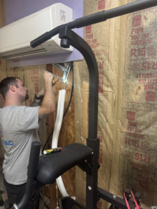 An HVAC technician working on mini-split wiring and piping for DD HVAC PROS in Charlotte, NC.