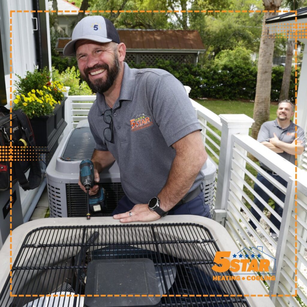 An HVAC technician performing maintenance on an outdoor air conditioning unit for 5 Star Charleston Heating and Air in Charleston, SC.