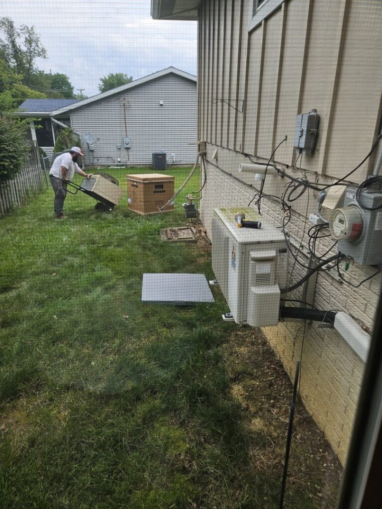 An HVAC technician working on an outdoor air conditioning unit for Great Lakes Heating & Air Conditioning in Wickliffe, OH.