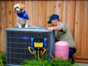 An HVAC technician working on an outdoor air conditioning unit for Specialty Heating and Cooling in Portland, OR.