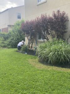 An HVAC technician performing service on an outdoor air conditioning unit for Major HVAC R Inc in Huntingdon Valley, PA