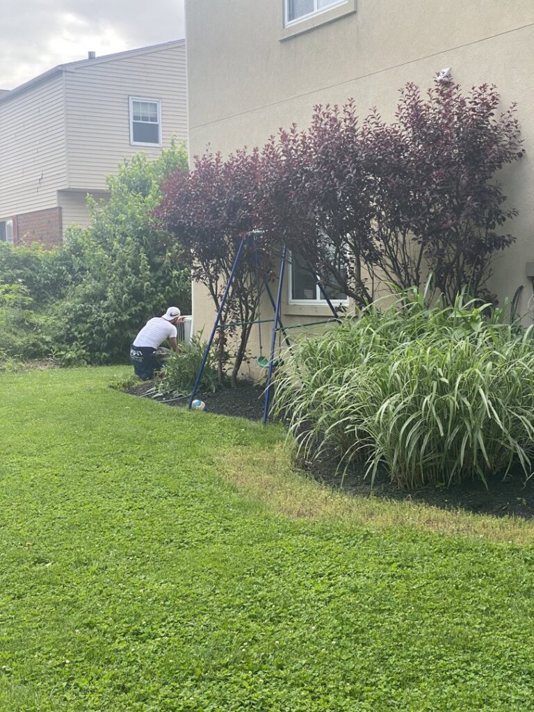 An HVAC technician performing service on an outdoor air conditioning unit for Major HVAC R Inc in Huntingdon Valley, PA